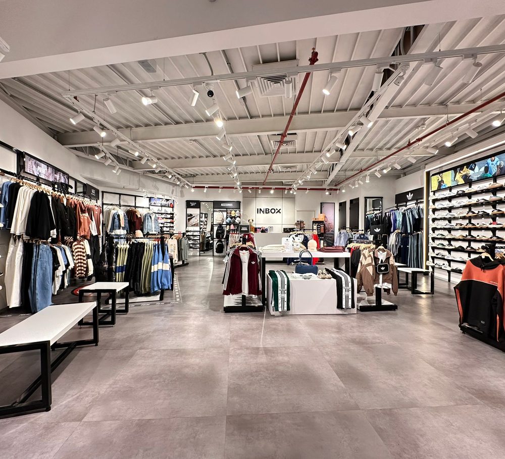 The Inbox store interior in Uruguay, apparel and footwear along both walls.